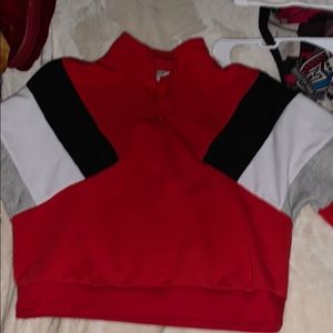 Red cropped long sleeve zip up shirt.